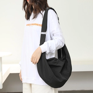 Minimalist black nylon hobo bag for women featuring a large capacity and casual design