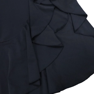 Close-up of ruffled hem details with fine stitching on dark blue evening dress fabric