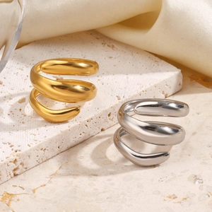 Minimalist spiral open ring in gold and silver finish on elegant silk background