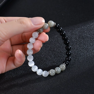 8mm moonstone and obsidian beaded elastic bracelet with silver spacers on hand