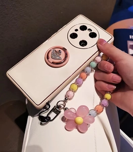 Detail of white phone case with macaron beads strap and sparkling swan ring holder