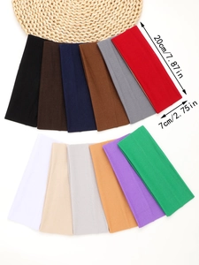 Top view of 12 multi-color elastic sports headbands arranged on a white background