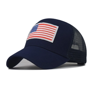 Detailed view of American flag embroidery on navy blue cotton mesh baseball cap
