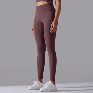Detail of high-waisted seamless ribbed leggings in dark purple for yoga and fitness