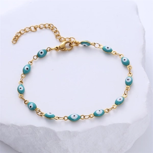 Detail of gold-plated stainless steel evil eye bracelet with 12 turquoise beads