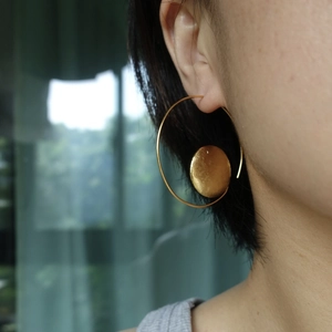 Minimalist gold asymmetrical sun and moon earrings with large hoop and solid disk charms