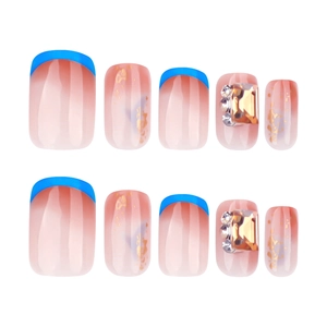 French blue press-on nails with luxury rhinestones and gold leaf on a nude gradient base