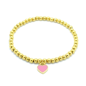 Detail of 4mm gold beaded bracelet featuring a pink enamel heart pendant on white background