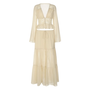 Close-up of beige chiffon layered skirt and lace cardigan with delicate tie-up detail