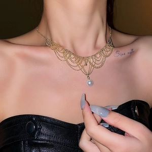 Close-up of a French lace-style pearl necklace with gold multi-layer beadwork on a model