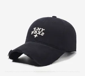 Close-up of black cotton baseball cap featuring distressed brim and star embroidery