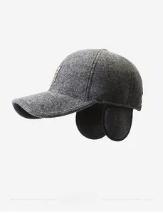 Close-up of wool baseball cap with earflaps and leather detail in dark grey
