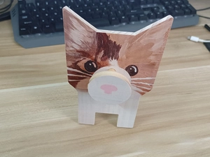 Close-up of a handcrafted wooden cat-shaped eyeglasses holder for desktop storage