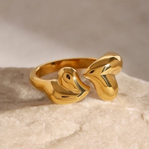 Polished gold stainless steel open ring with dual heart accents on natural stone