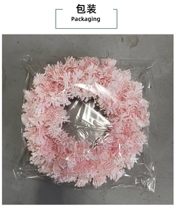 Pink cherry blossom Christmas wreath detail showing packaging for holiday door decoration
