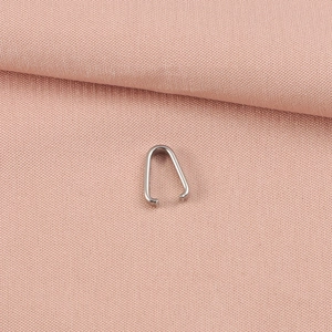 Close-up of polished stainless steel pinch bail pendant connector for DIY jewelry making