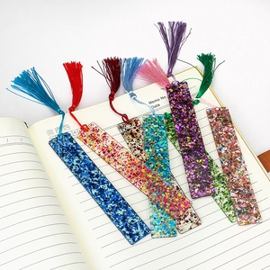 Detailed view of handmade rectangular acrylic bookmarks with colorful tassels and sequins