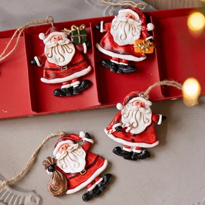Set of 4 vintage resin Santa Claus ornaments with rustic twine in a festive red gift box