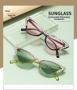 Detail of trendy cat-eye sunglasses featuring colorful rhinestones and gradient lenses