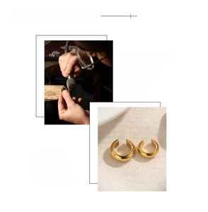 Detail of 18K gold plated C-shaped earrings with artisan craftsmanship and hand polishing