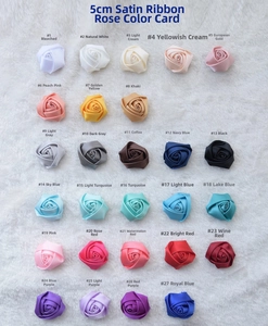 Detailed chart showing 27 colors of 5cm handmade satin rose boutonnieres on plush white fabric