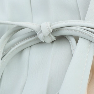 French style light green A-line dress featuring cross halter neck and tied waist detail