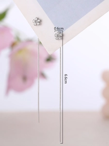 Macro view of silver tassel earrings showing 6.6cm length and 0.6cm flower detail