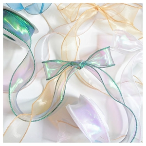 Close-up of iridescent organza ribbon layers in champagne and white for gift wrapping