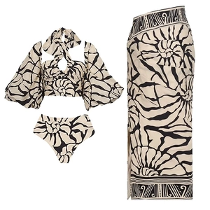 Detailed flat lay of a 3-piece swimwear set with shell print, top, bottom, and long wrap skirt