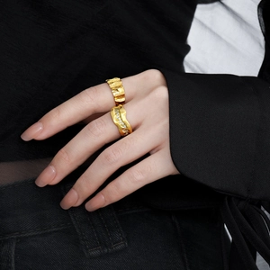 Irregular wrinkled texture and wavy diamond rings in gold finish worn by model