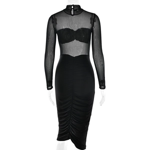 Detail view of the sheer mesh back, button closure and ruched fabric of the black dress