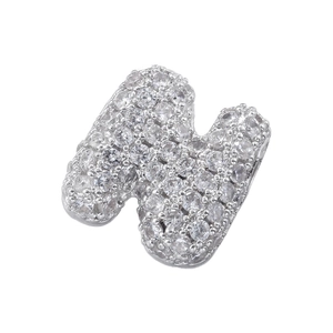 Detailed close-up of a silver-tone pavé-set letter N pendant with sparkling zircons