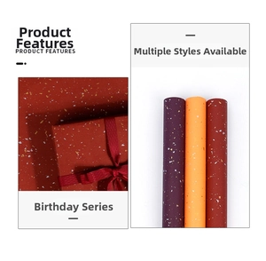 Detail of metallic gold and silver foil patterns on premium colorful gift wrapping paper rolls