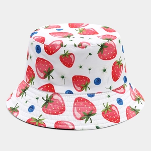 Detailed stitching and vibrant strawberry pattern on a white cotton bucket hat