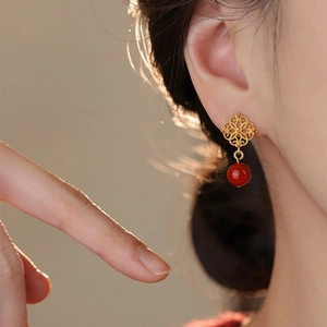 Elegant Chinese style hollow flower stud earrings with red beads and golden finish