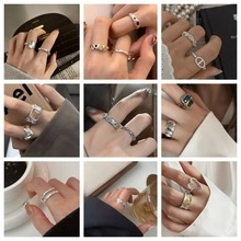 Close-up of vintage silver stackable rings featuring heart and chain link designs