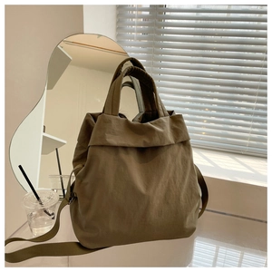 Army green nylon tote bag featuring natural crinkled texture and wide shoulder straps