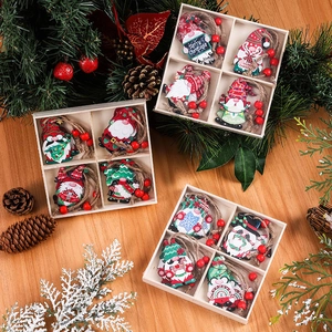 Set of 12 festive wooden Christmas gnome ornaments with hanging ropes on a wooden table