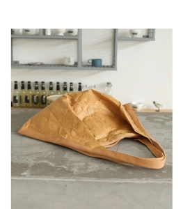 Detailed texture of brown crumpled paper handbag on a modern coffee shop counter