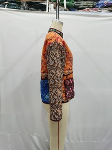 Detailed side view of ethnic patchwork quilted cotton jacket featuring floral prints