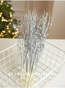 Silver Christmas tree glitter branches with decorative pearls in a wire basket