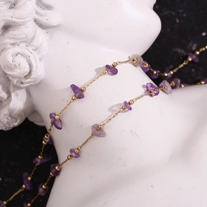 Detailed shot of 18K gold plated chain with irregular purple amethyst stones and beads