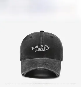 Detail of vintage washed black baseball cap with white RUN TO THE SUNSET embroidery