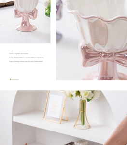 Detail view of a white ceramic goblet featuring a pink bow and elegant base design