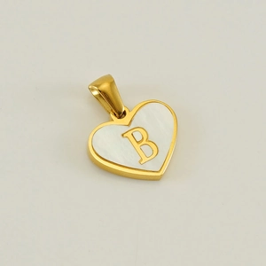 Macro view of gold heart pendant featuring a white shell inlay and a golden letter B detail