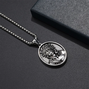 Close-up of vintage silver Jesus relief oval pendant with a square box chain for men