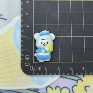 Close-up of small resin sailor bear figurine showing 2.5cm size scale on a ruler