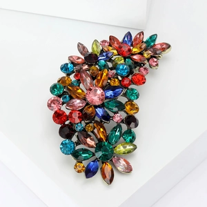 Detailed macro view of retro floral brooch with colorful rhinestones and vintage metal