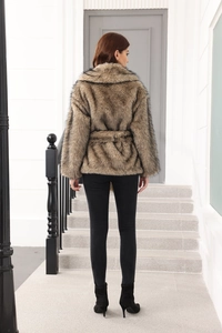 Back view of brown faux fur coat for women with belted waist on modern stairs