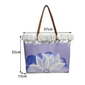 Detail view of purple floral tote bag with fringe, measuring 47cm width and 35cm height
